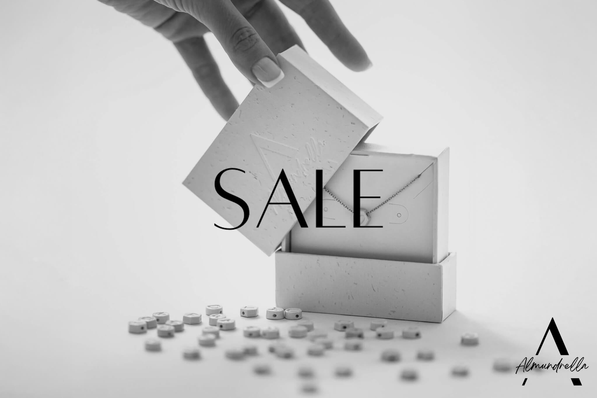 Hand opening an Almundrella porcelain necklace box – SALE event