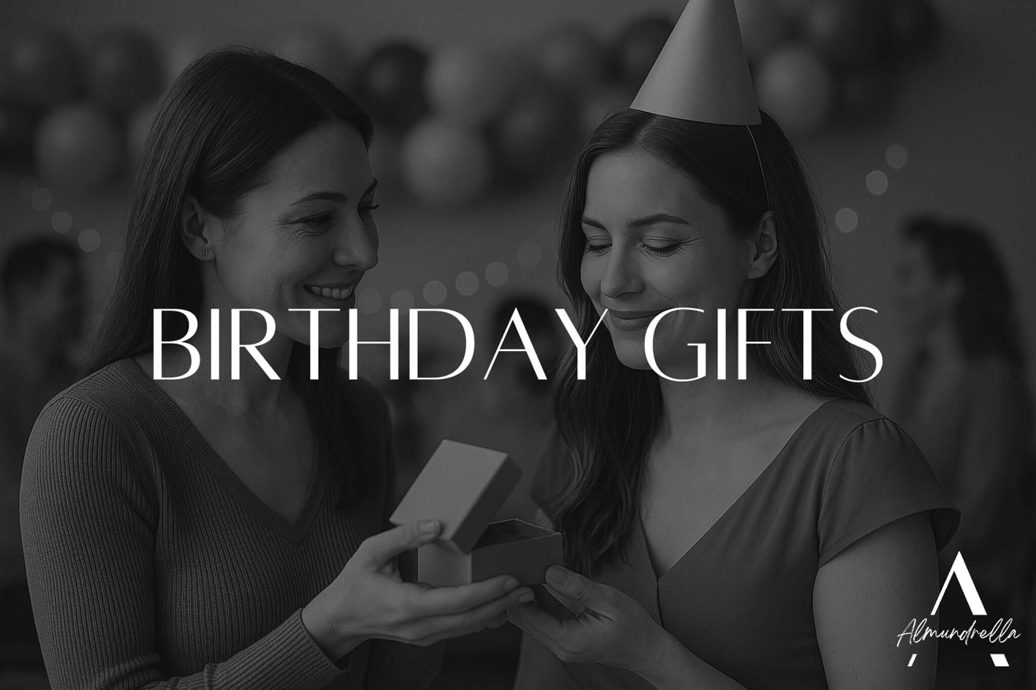 Two women at a birthday party, one gifting a small jewelry box to the other wearing a party hat – emotional black and white moment for birthday gift inspiration