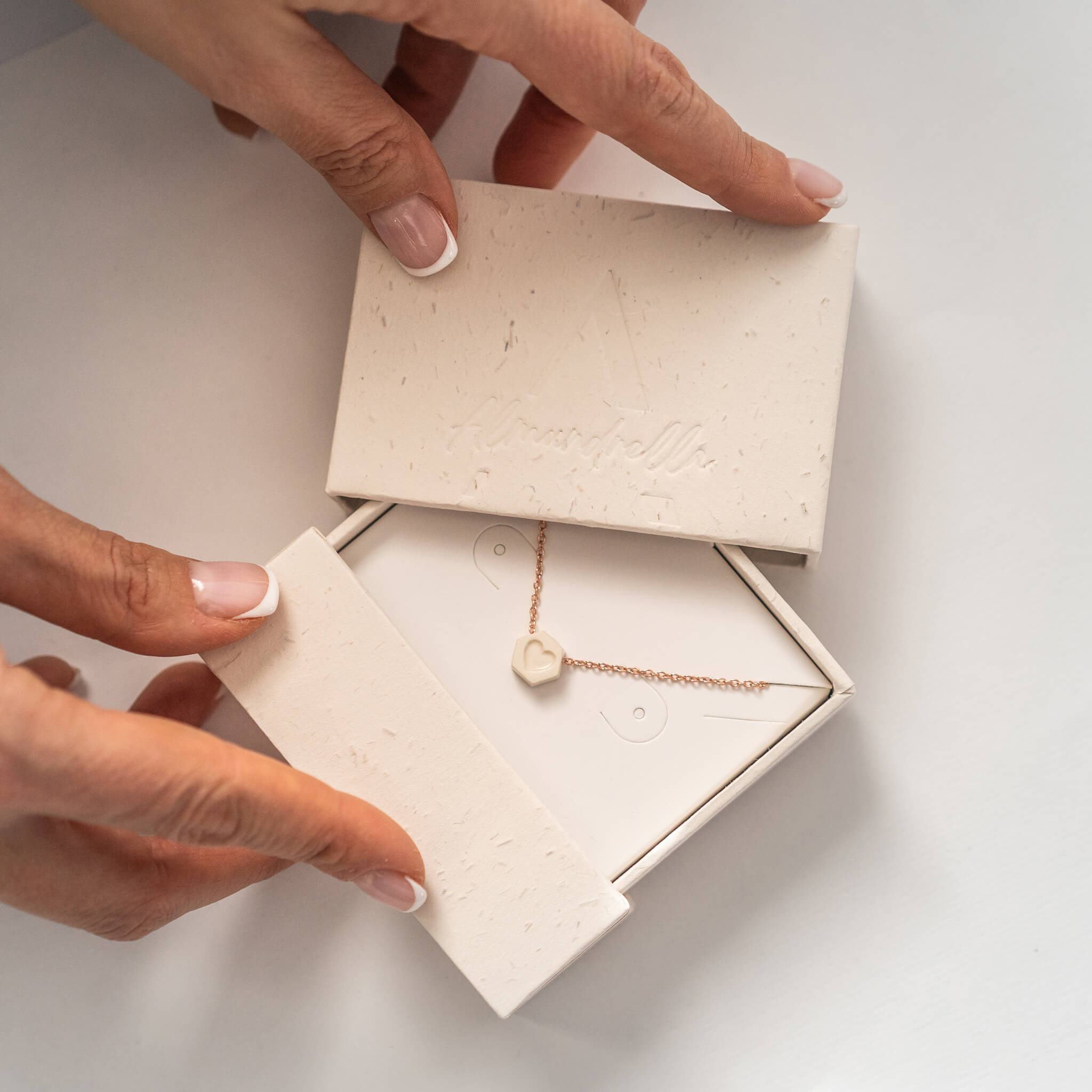 Handmade porcelain mother-daughter necklace with heart pendant, presented in an eco-friendly Almundrella gift box.
